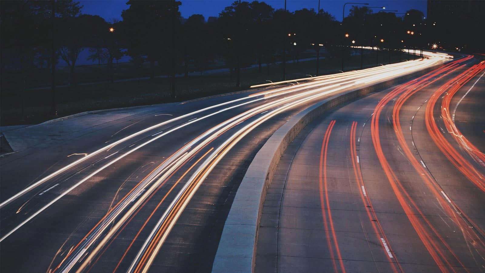 Long exposure of evening traffic lights on highway.