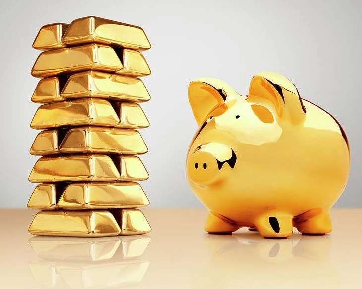 Gold bars pile and piggy bank.
