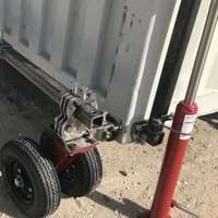 Damaged trailer hitch and red jack stand.