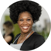 Woman smiling with curly afro hair.