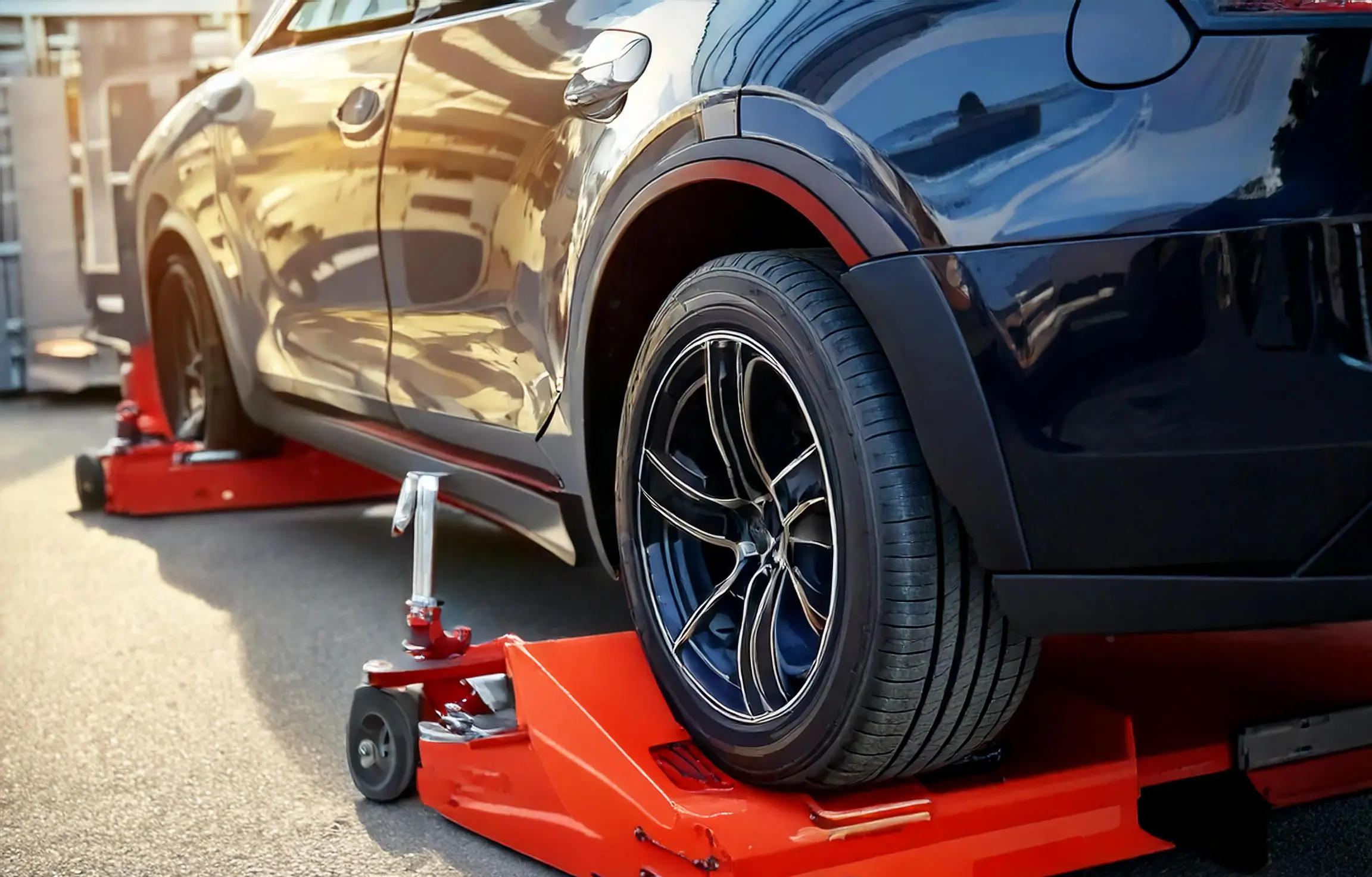 Showing image that using wheel dollies for supercar to move